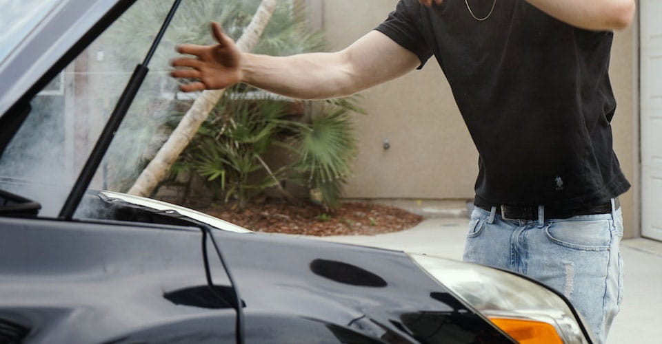 Man with car hood open
