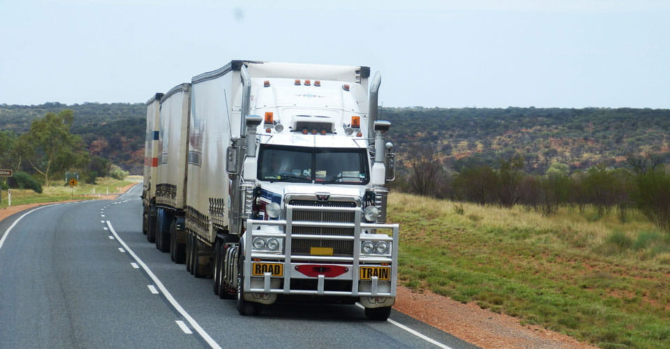 Road train driving down a country road