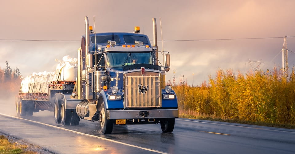 Semi truck driving down the road