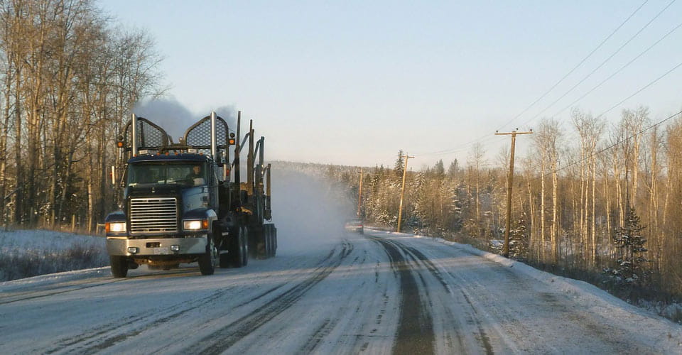 Truck driving down an icy country road