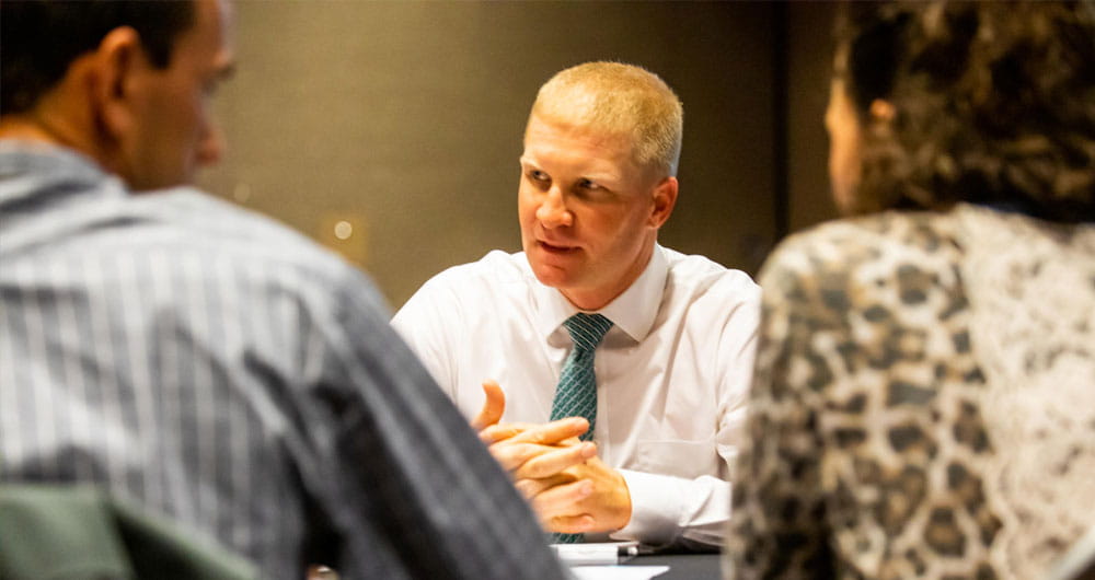 Man wearing a tie sitting at a table