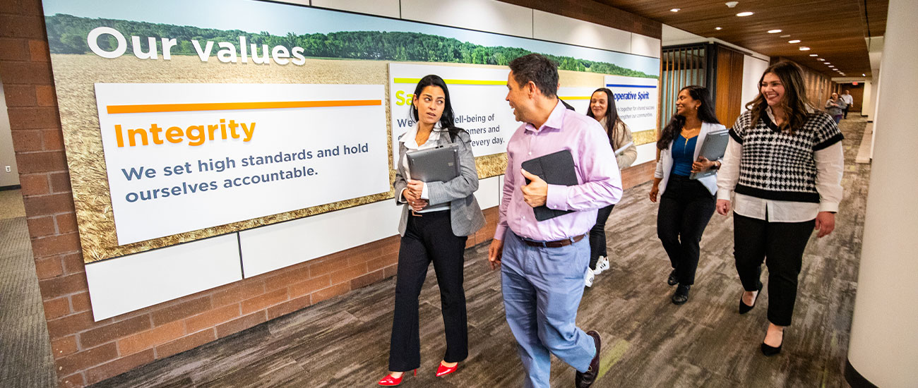 group walking by CHS company values on wall