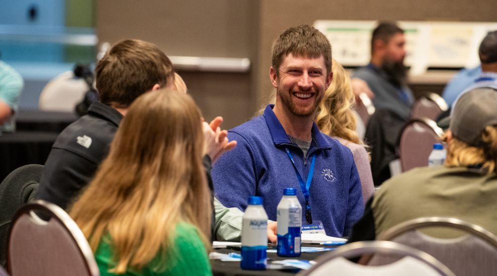 A group of men and women sitting around a table