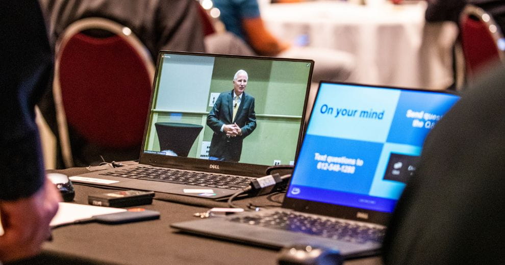 Two computer screens showing a virtual meeting.