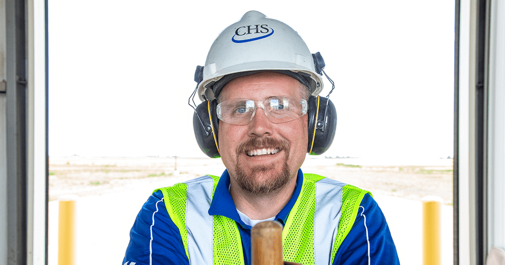 man smiling with a hard helmet on 