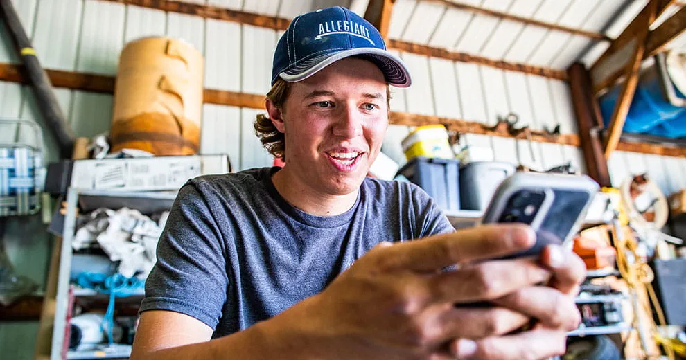 Man looking down and typing on cell phone