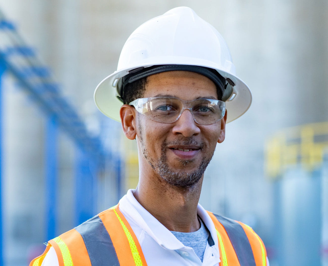 Employee smiling with hard hat