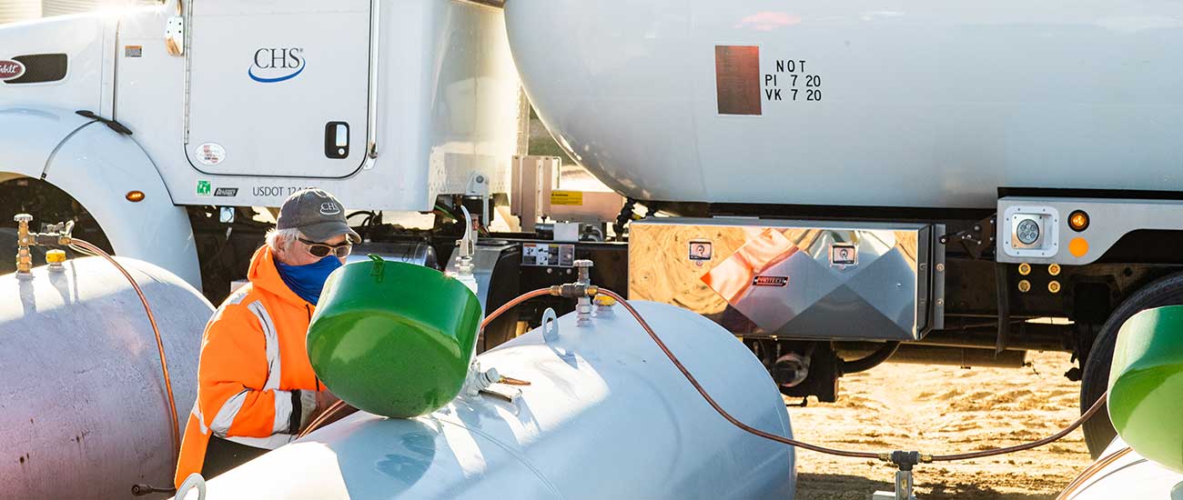 man filling propane tanks