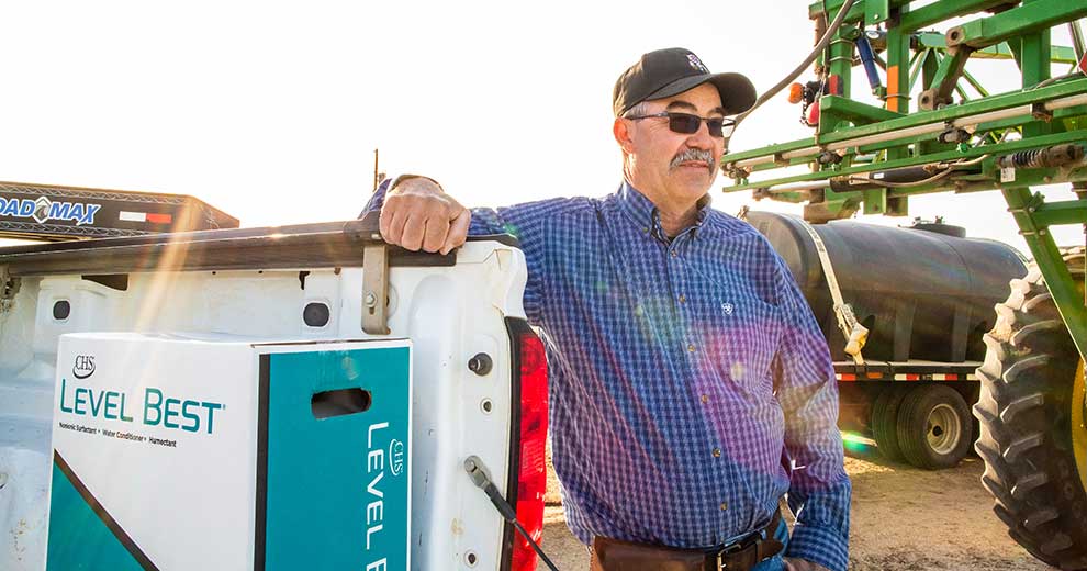man standing next to truck with box of Level Best