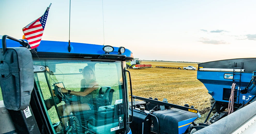 Blue tractor with an American flag attached to it