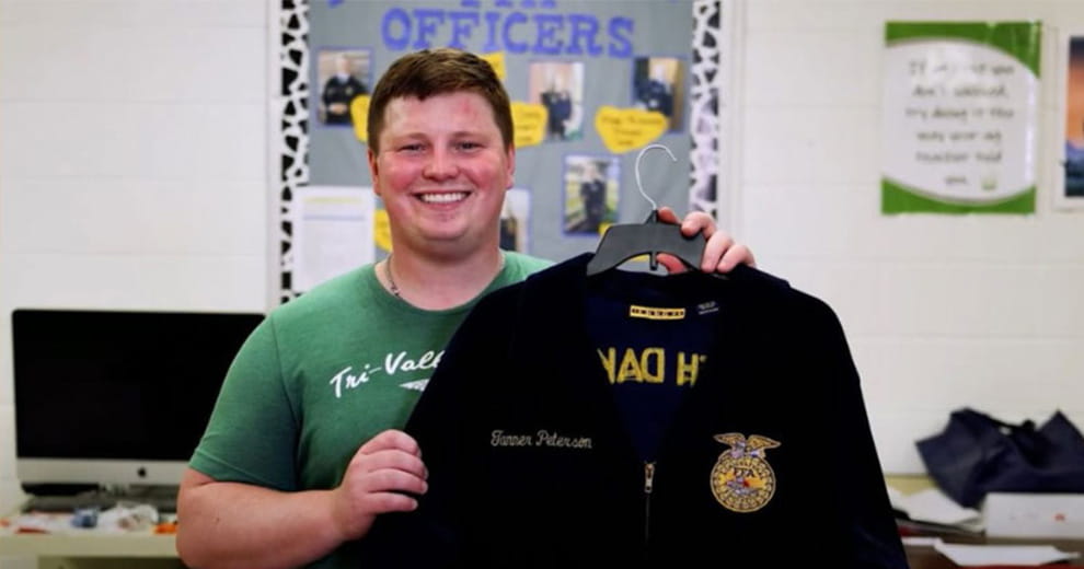 Man holding up a FFA jacket