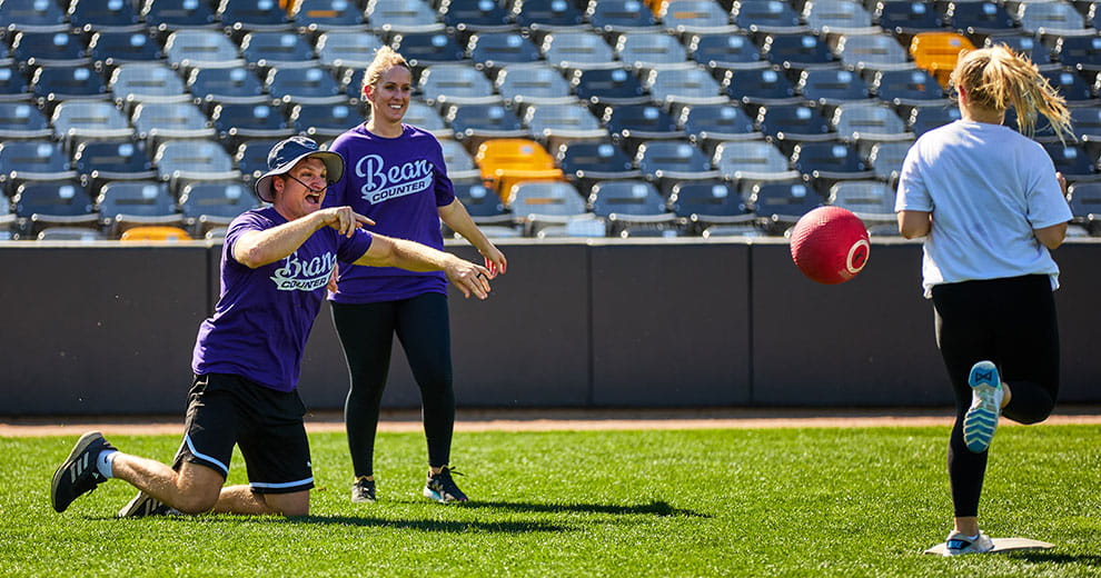 People playing kickball on a soccer field