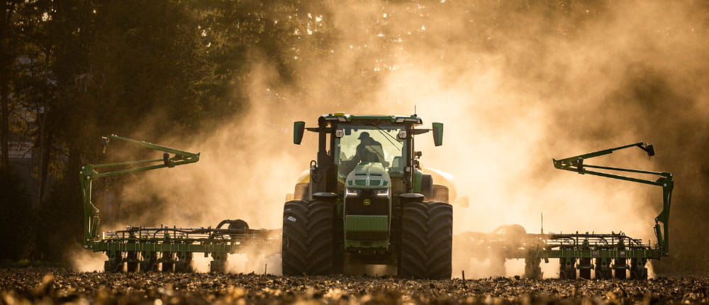 man in tractor planting in a field