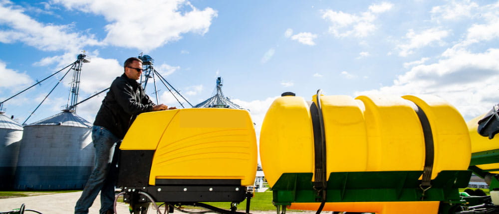 man leaning on a sprayer
