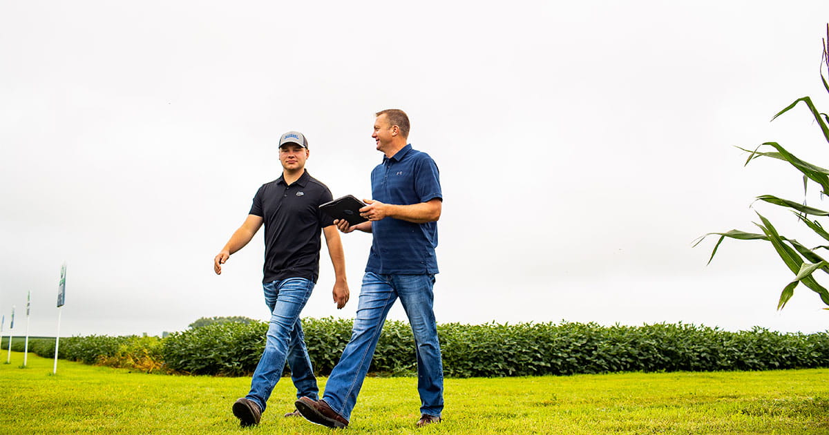 Two men walking through an open field