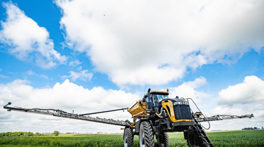 Sprayer in a field under cloudy skies
