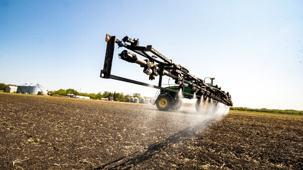 A sprayer applying chemicals in a field