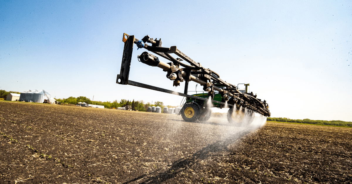 A sprayer applying chemicals in a field