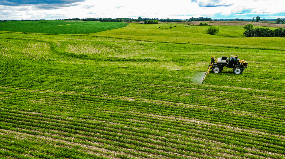 Sprayer applying treatment in a field