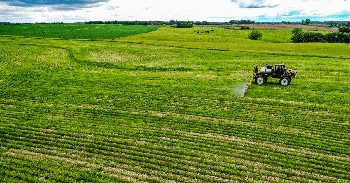 Sprayer applying treatment in a field