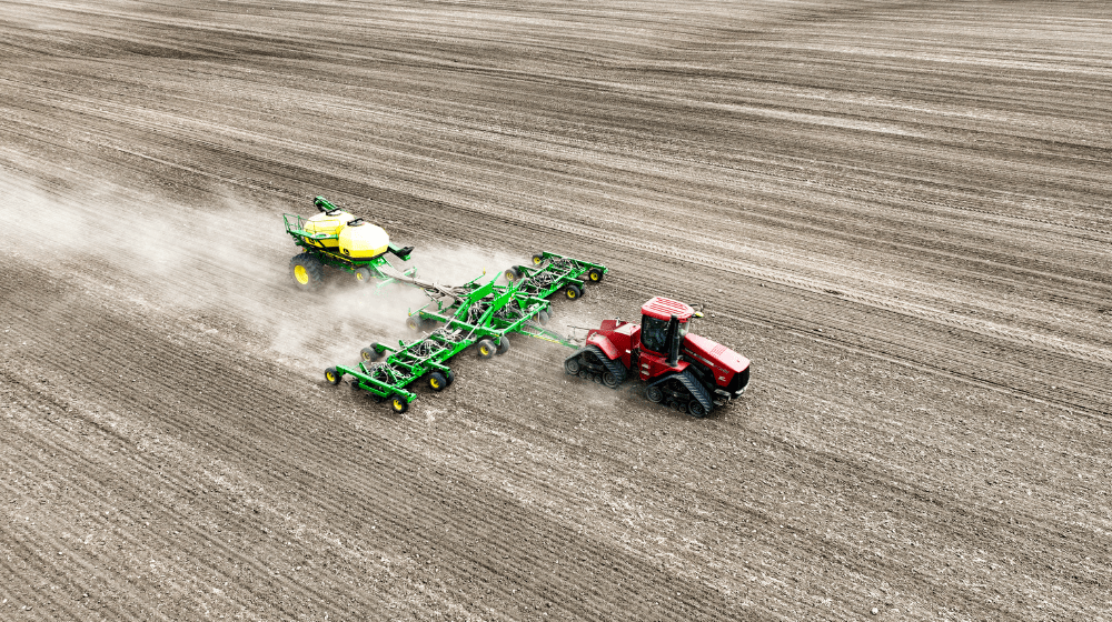 Tractor pulling planter across a field