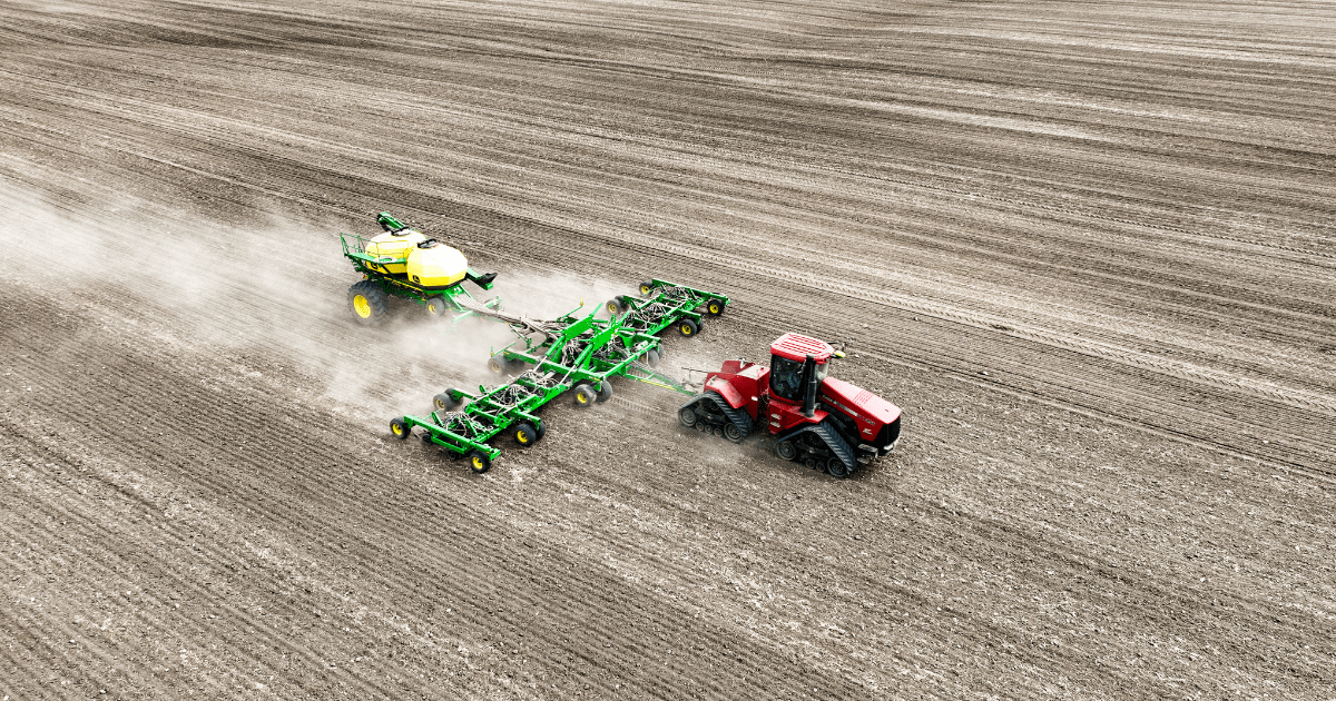 Tractor pulling planter across a field