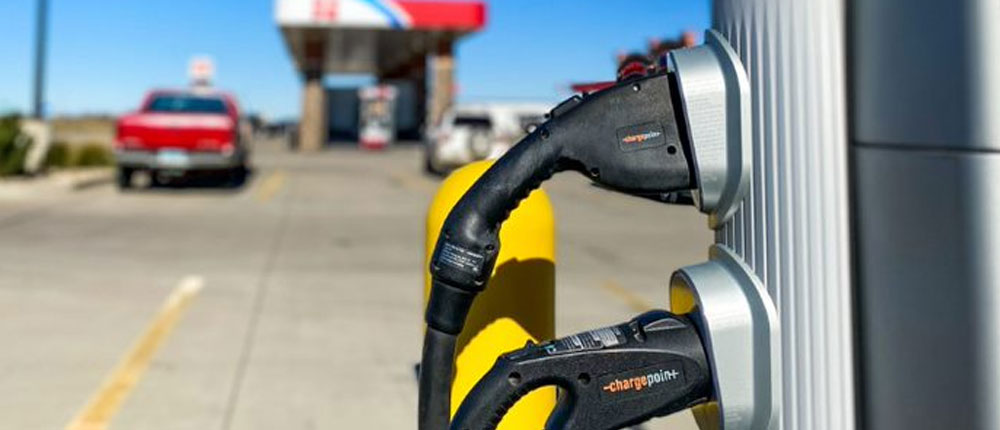 An electric vehicle charging station at a gas station.