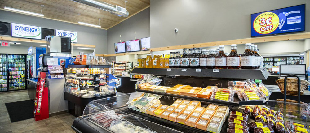 A cooler inside a gas station holds Wisconsin meats and cheeses