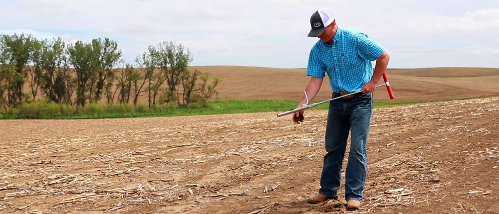 An agronomist does an Advanced Soil Analytics soil test in a field in Nebraska.