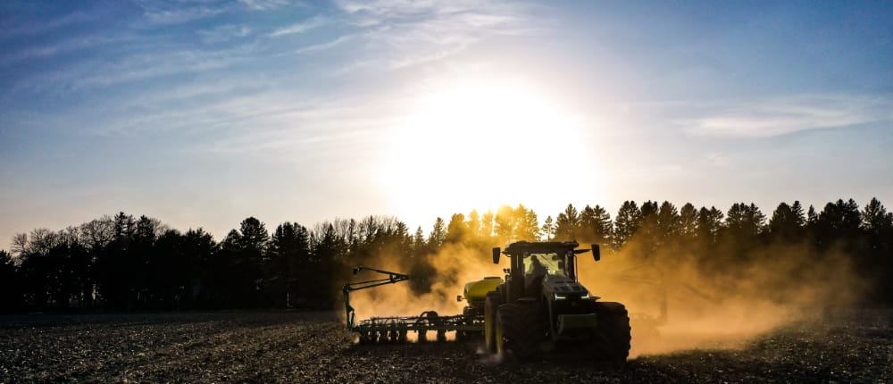 A tractor, powered by diesel fuel, gets a field ready for planting