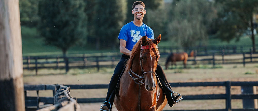 College student riding a horse