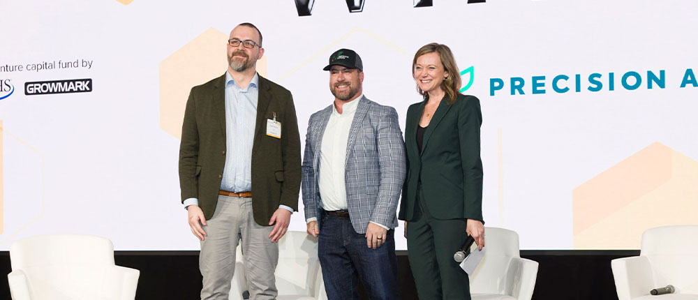 Three people standing on a stage