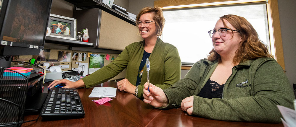 Two women working on a computer