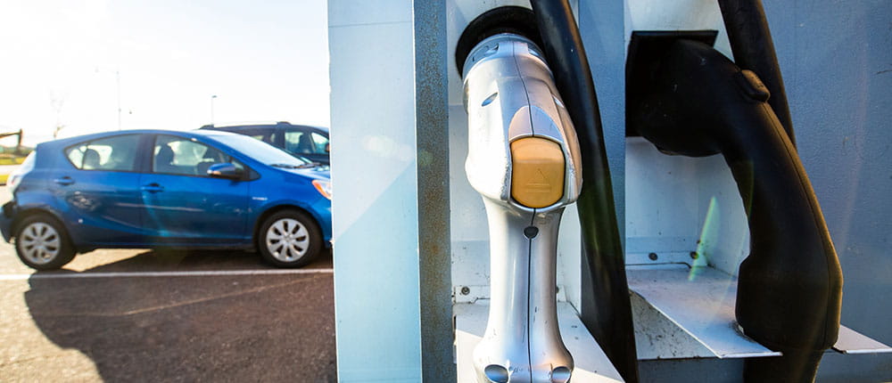 Electric car next to charging station.