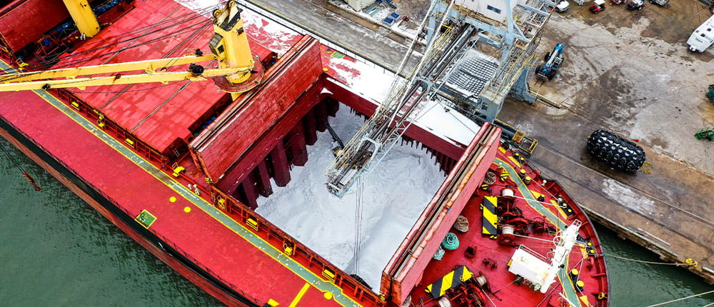 Granular fertilizer being unloaded from a cargo ship