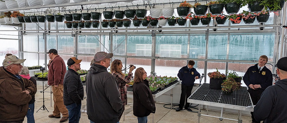 Group of people touring a greenhouse