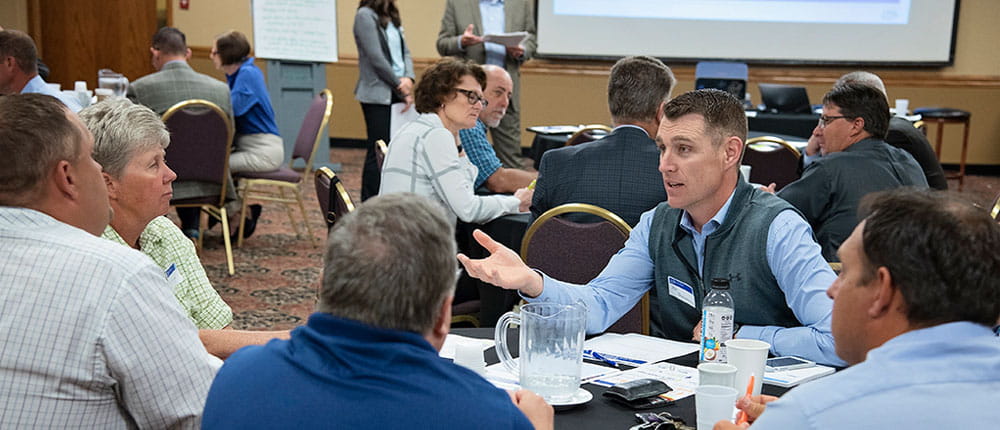 people men women talking tables conference forum owners