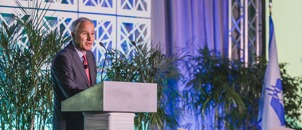 Jay Debertin speaks at podium