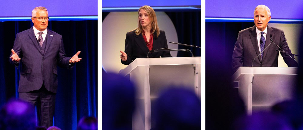 Dan Schurr, Olivia Nelligan and Jay Debertin on stage at the 2022 CHS Annual Meeting