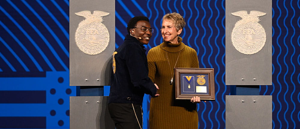 Nanci Lilja on stage being presented with an award