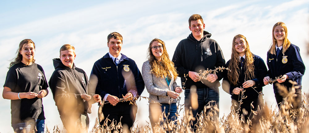 Teacher and students in field.