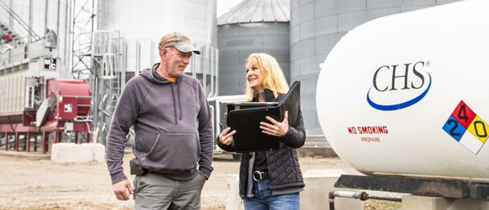 Certified Energy Specialist speaks with CHS propane customer on farm