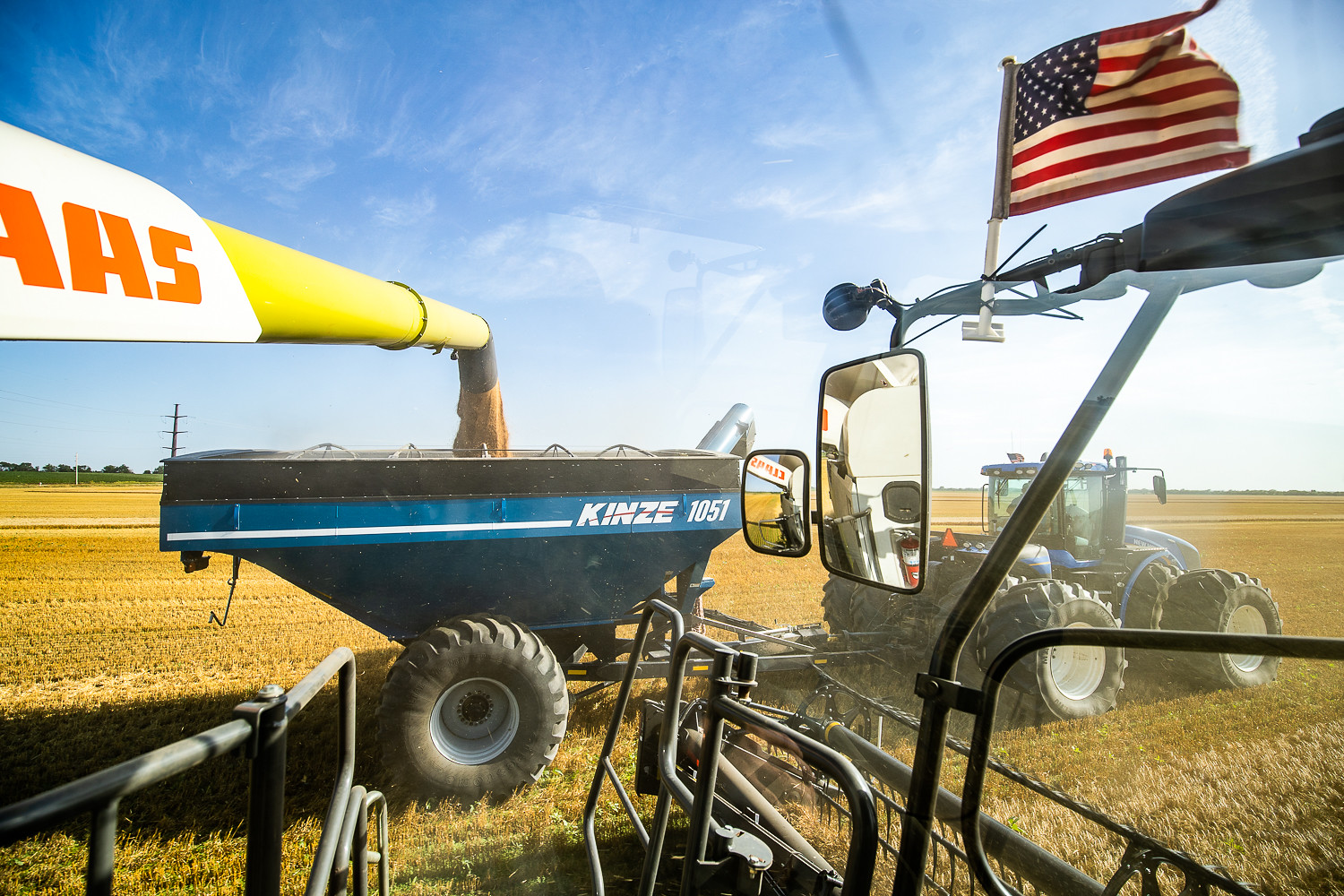 Wheat streaming from the combine to the grain cart
