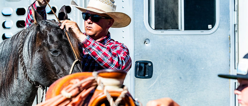 rancher kyler beard preparing horse