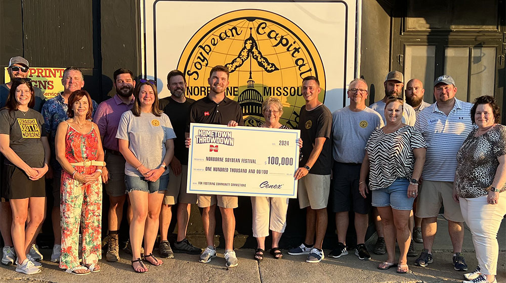 Group of people holding up the Hometown Throwdown giant grand prize check