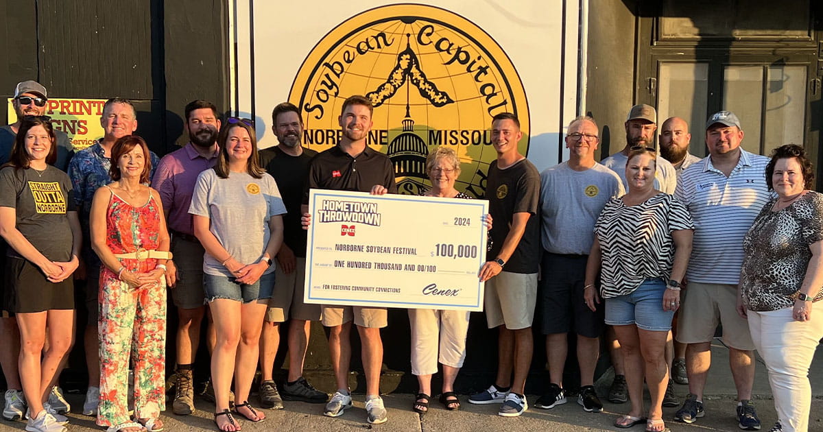 Group of people holding up the Hometown Throwdown giant grand prize check