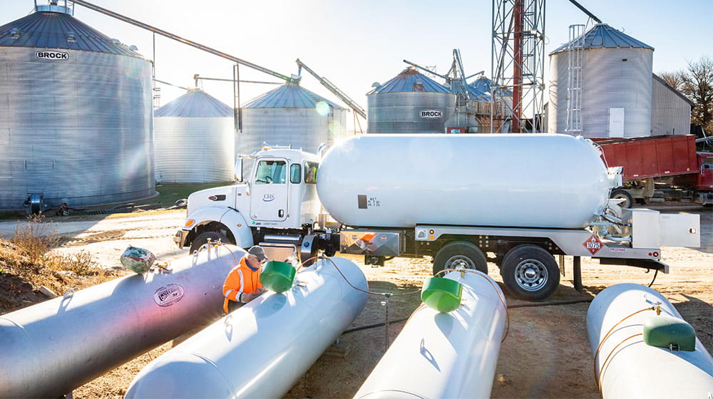 Worker putting propane into tanks