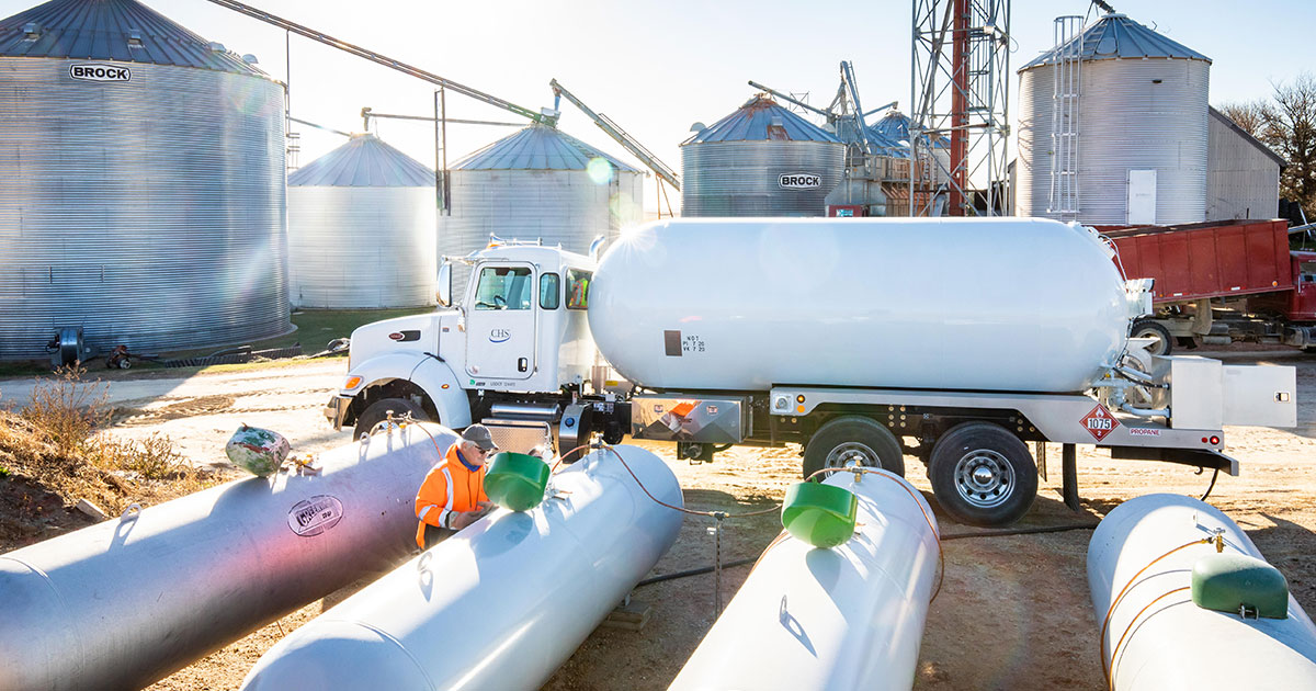 Worker putting propane in tanks