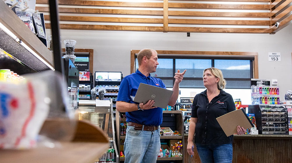 Man and woman talking in a convenience store