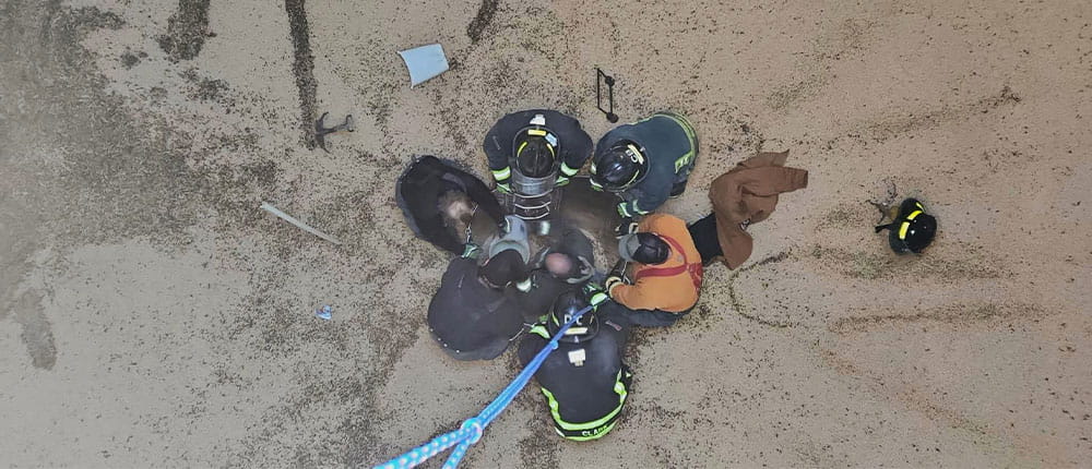 Firefighters building a coffer dam as part of a grain-engulfment rescue